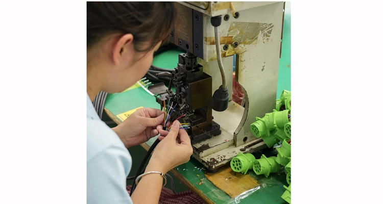 Close-up of precision wire crimping and terminal assembly for high-quality automotive cables.